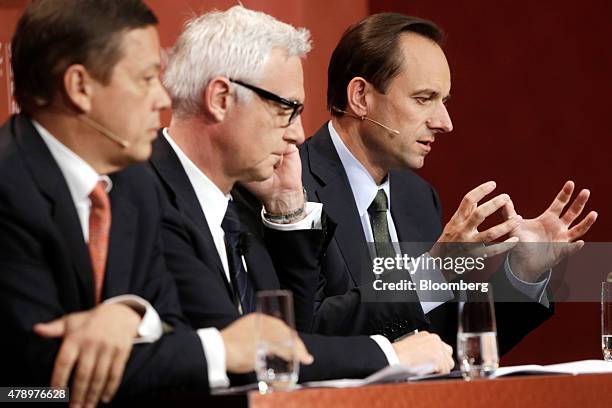 Alexandre Zeller, chairman of SIX Group AG, left, Urs Rohner, chairman of Credit Suisse Group AG, centre, listen as Mark Branson, chief executive...