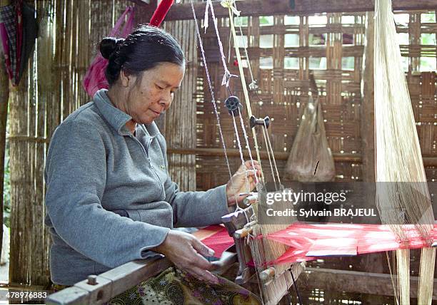 Laotian woman weaves silk, in Luang Prabang, Laos.