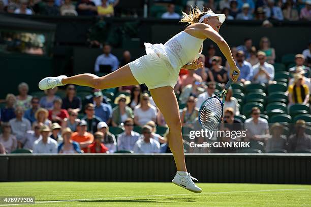 Russia's Maria Sharapova serves to Britain's Johanna Konta during their women's singles first round match on day one of the 2015 Wimbledon...