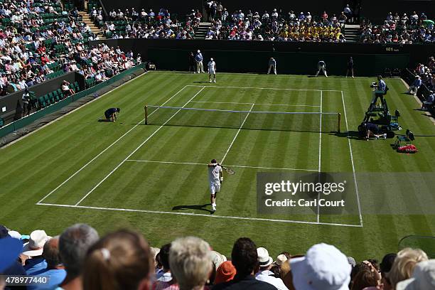 Lleyton Hewitt of Australia wipes his head during his match with Jarkko Nieminen of Finland during their gentlemen's singles match on day one of...