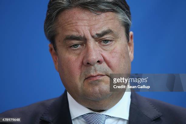 German Vice Chancellor and Economy and Energy Minister Sigmar Gabriel and Chancellor Angela Merkel speaks to the media following an extraordinary...