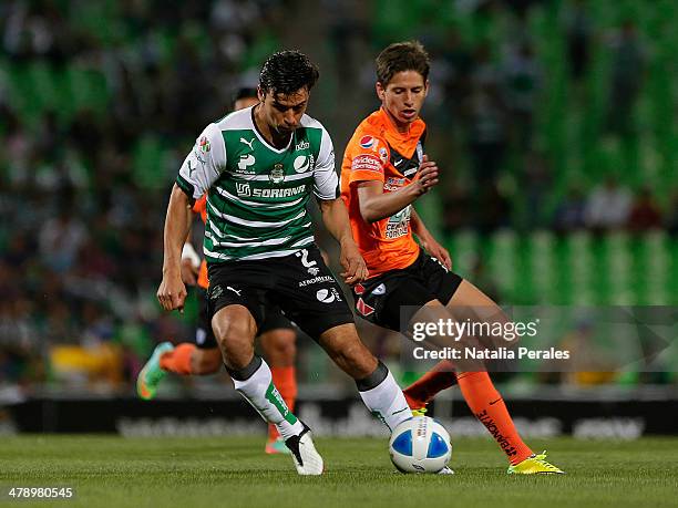 Oswaldo Alanis of Santos drives the ball against a rival during a match between Santos Laguna and Pachuca as part of the Round 11th of Clausura 2014...