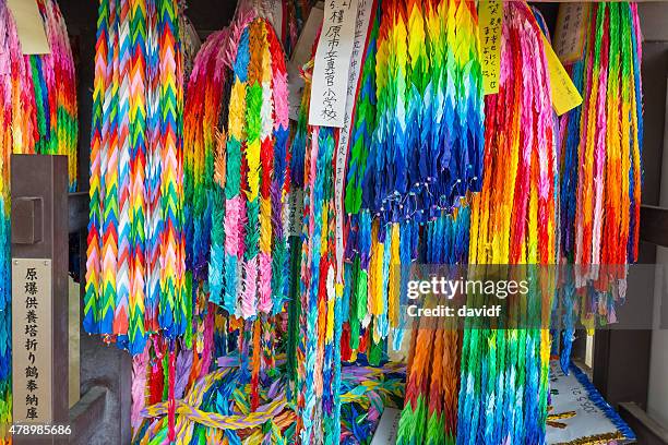 brightly coloured origami paper cranes in hiroshima - hiroshima peace memorial stock pictures, royalty-free photos & images