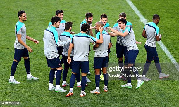 Team members of Portugal joke with Joao Mario during a training session ahead of the UEFA European Under-21 final match against Sweden at Eden...