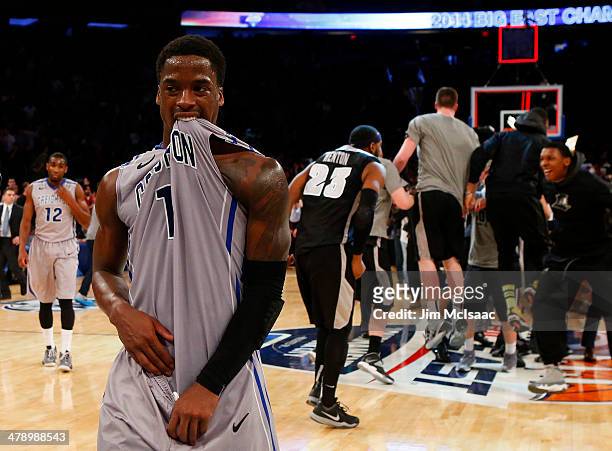 Austin Chatman of the Creighton Bluejays walks off of the court dejected as the Providence Friars celebrate their 65 to 58 win in the Championship...