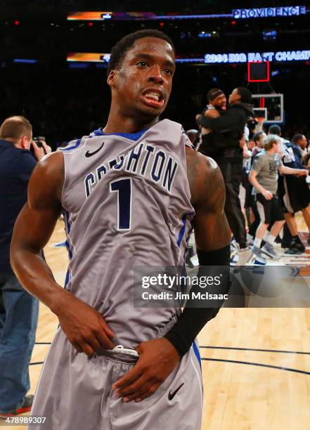 Austin Chatman of the Creighton Bluejays walks off of the court dejected as the Providence Friars celebrate their 65 to 58 win in the Championship...