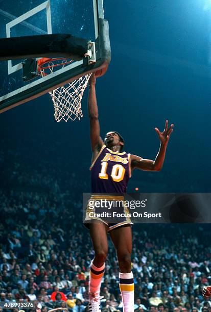 Norm Nixon of the Los Angeles Lakers goes up for a layup against the Washington Bullets during an NBA basketball game circa 1978 at the Capital...