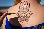 henna tattoo mehendy painted on back hamsa