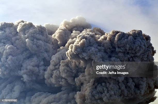 Mount Sinabung, continues to erupt and spew gas and ash into the sky on June 29, 2015 in Karo, Indonesia. Around 10,000 people remain in temporary...