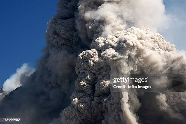 Mount Sinabung, continues to erupt and spew gas and ash into the sky on June 29, 2015 in Karo, Indonesia. Around 10,000 people remain in temporary...