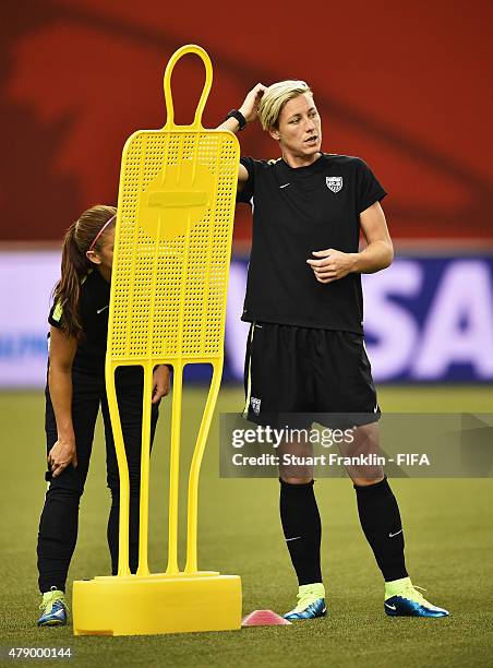 Alex Morgan and Abby Wambach of USA ponder during a training session prior to the FIFA Women's World Cup Semi Final match between USA and Germany at...