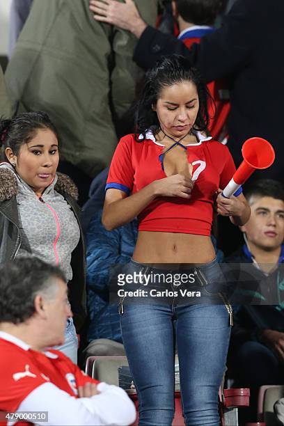 Fan of Chile enjoys the atmosphere prior to the 2015 Copa America Chile Semi Final match between Chile and Peru at Nacional Stadium on June 29, 2015...
