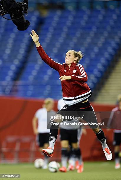 Simone Laudehr of Germany tries to catch the spider cam during a training session at Olympic Stadium ahead of their semi final match against the...