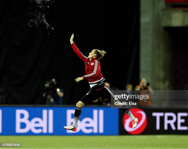 Simone Laudehr of Germany jumps for the Spider camera during training at Olympic Stadium on June 29, 2015 in Montreal, Canada.