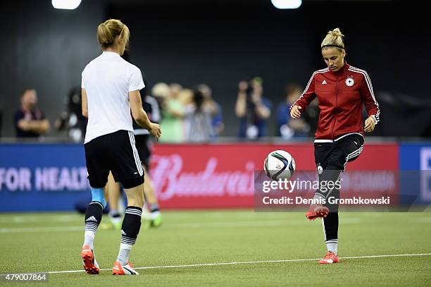 Bianca Schmidt and Jennifer Cramer of Germany practice during a training session at Olympic Stadium ahead of their semi final match against the...