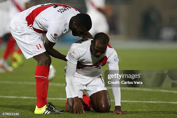 Christian Ramos helps his teammate Luis Advincula of Peru after the 2015 Copa America Chile Semi Final match between Chile and Peru at Nacional...