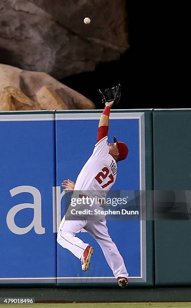 Center fielder Mike Trout the Los Angeles Angels of Anaheim makes a leaping catch as he runs down a ball hit by Chris Young of the New York Yankees...