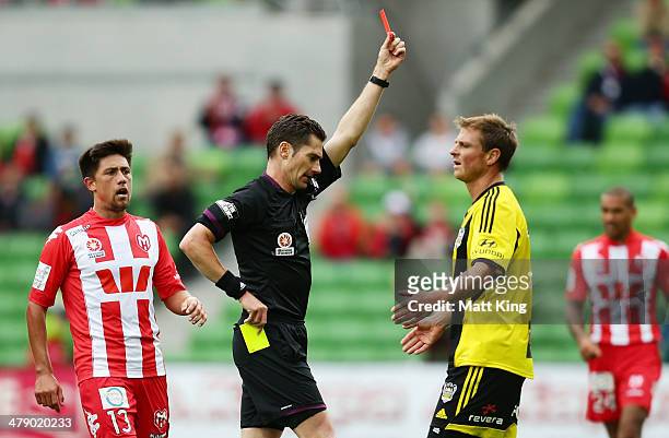 Ben Sigmund of the Phoenix is given a red card by referee Ben Williams after his second yellow card for a foul on Harry Kewell of the Heart during...