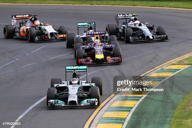 Nico Rosberg of Germany and Mercedes GP leads the field into the first corner at the start of the Australian Formula One Grand Prix at Albert Park on...