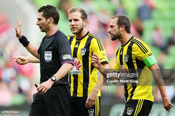 Andrew Durante and Jeremy Brockie of the Phoenix argue with referee Ben Williams after he awarded a penalty to the Heart for a foul on Harry Kewell...