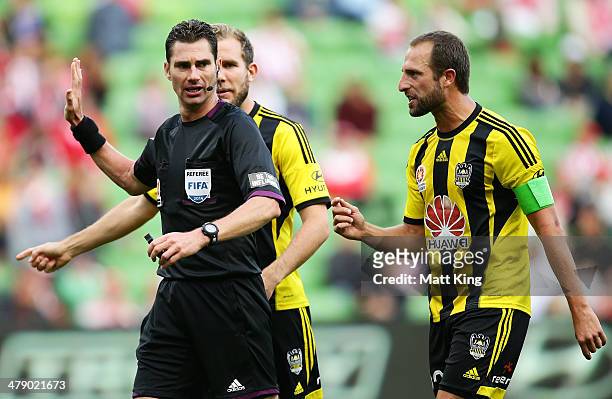 Andrew Durante and Jeremy Brockie of the Phoenix argue with referee Ben Williams after he awarded a penalty to the Heart for a foul on Harry Kewell...