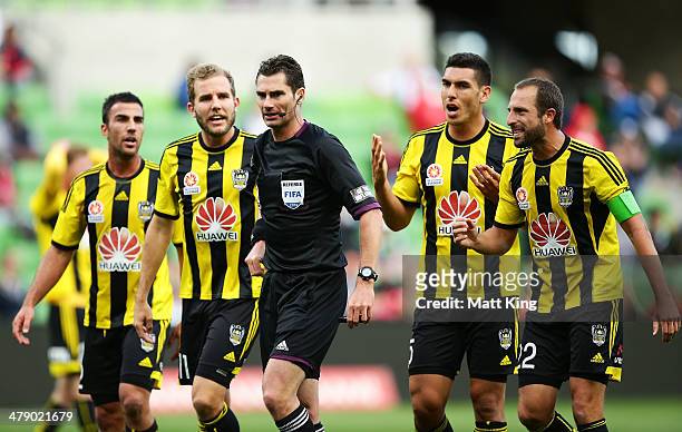 Phoenix players argue with referee Ben Williams after he awarded a penalty to the Heart for a foul on Harry Kewell during the round 23 A-League match...