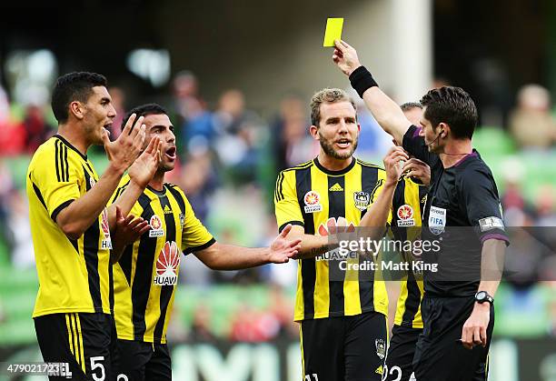 Phoenix players argue with referee Ben Williams after he awarded a penalty to the Heart for a foul by Manny Muscat of the Phoenix on Harry Kewell of...