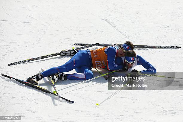 Guide Julien Bourla embraces Thomas Clarion of France as they celebrate winning the bronze in the men's 10km - Visually Impaired cross-country skiing...