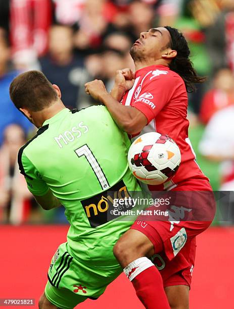 David Williams of the Heart clashes with Phoenix goalkeeper Glen Moss during the round 23 A-League match between Melbourne Heart and the Wellington...