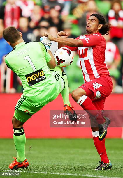 David Williams of the Heart clashes with Phoenix goalkeeper Glen Moss during the round 23 A-League match between Melbourne Heart and the Wellington...