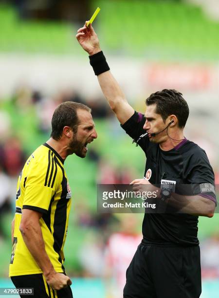 Phoenix captain Andrew Durante argues with referee Ben Williams and is given a yellow card during the round 23 A-League match between Melbourne Heart...