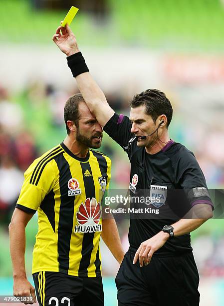 Phoenix captain Andrew Durante argues with referee Ben Williams and is given a yellow card during the round 23 A-League match between Melbourne Heart...