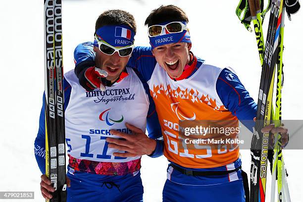 Bronze medalist Thomas Clarion of France and guide Julien Bourla celebrate after crossing the finish line in the Mens Cross Country 10km Free ...