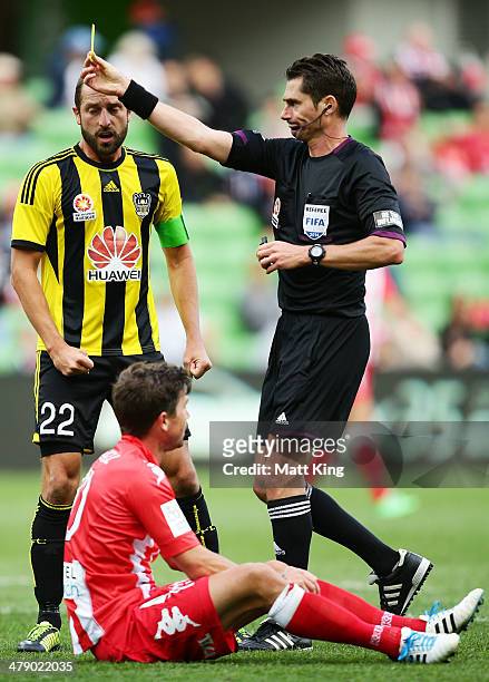 Andrew Durante of the Phoenix argues with referee Ben Williams after he awarded a penalty to the Heart for a foul on Harry Kewell during the round 23...