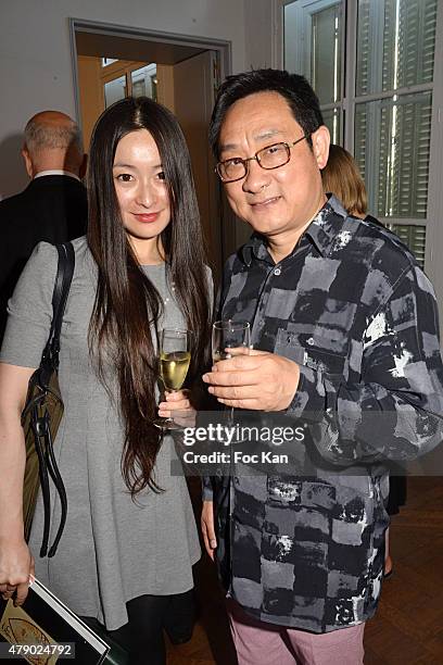 Wen Yang and Chinese painter Jiang Shanqing attend the Marisa Schiaparelli Berenson book signing at Christies on June 29, in Paris France.