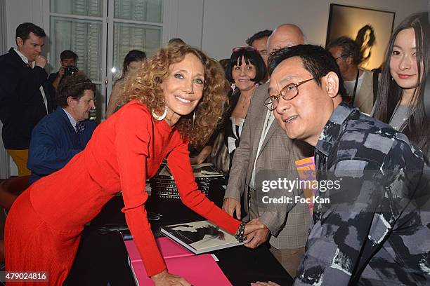 Marisa Berenson and Chinese painter Jiang Shanqing attend the Marisa Schiaparelli Berenson book signing at Christies on June 29, in Paris France.