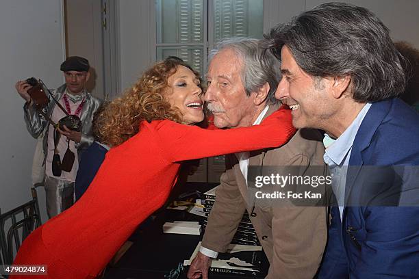 Marisa Berenson, Jean Rochefort and Alexandre Zouari attend the Marisa Schiaparelli Berenson book signing at Christies on June 29, in Paris France.