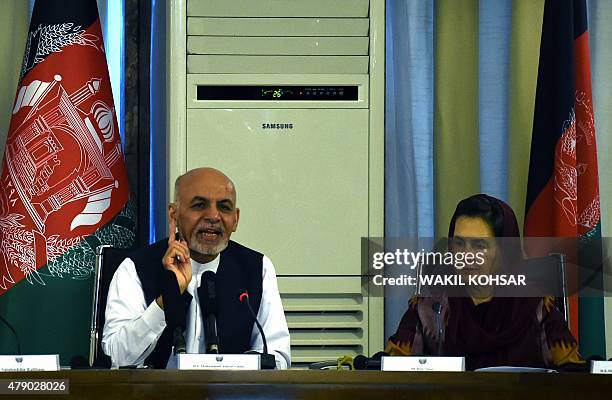 Afghan President Ashraf Ghani speaks as his wife first Lady Rula Ghani listens during a gathering of diplomats and women rights activits at The...