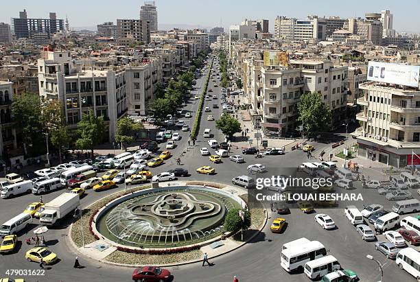 General view shot taken on June 30 shows traffic on a roundabout in the Syrian capital Damascus. AFP PHOTO / LOUAI BESHARA