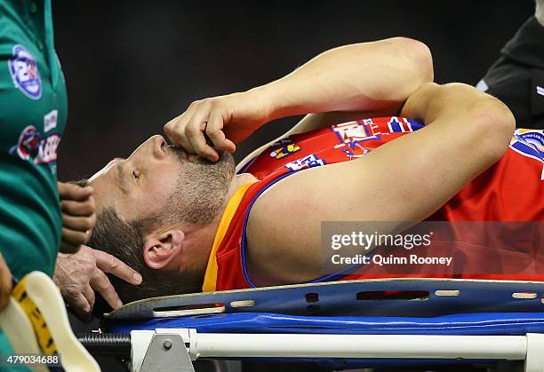 Russell Robertson of the All Stars is stretchered off during the EJ Whitten Legends Game at Etihad Stadium on June 30, 2015 in Melbourne, Australia.