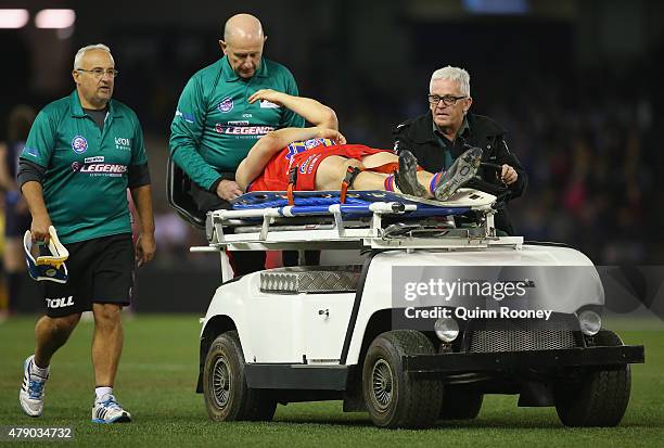 Russell Robertson of the All Stars is stretchered off during the EJ Whitten Legends Game at Etihad Stadium on June 30, 2015 in Melbourne, Australia.