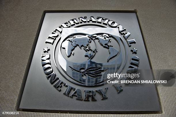 Logo is seen outside the headquarters of the International Monetary Fund June 30, 2015 in Washington, DC. AFP PHOTO/BRENDAN SMIALOWSKI