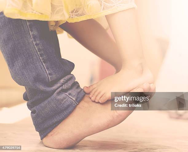 father dancing with his daughter - baby pants with feet stock pictures, royalty-free photos & images