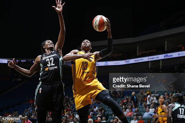 Karima Christmas of the Tulsa Shock goes for the layup against Swin Cash of the New York Liberty on June 26, 2015 at the BOK Center in Tulsa,...
