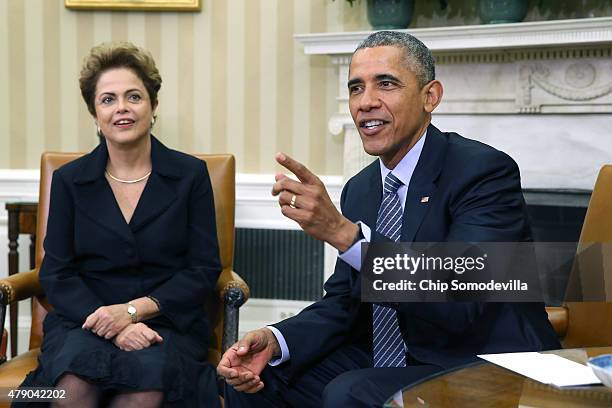 Brazilian President Dilma Rousseff and U.S. President Barack Obama pose for photographs in the Oval Office at the White House June 30, 2015 in...