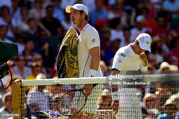 Andy Murray of Great Britain and his Gentlemens Singles first round match opponent Mikhail Kukushkin of Kazakhstan are seen on court in the hot...