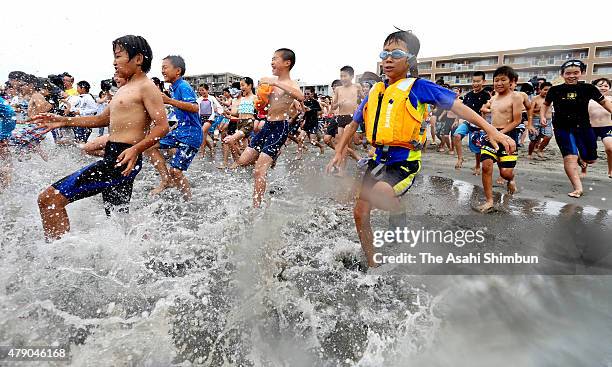 Children play in the sea as a beach opens on June 26, 2015 in Zushi, Kanagawa, Japan.