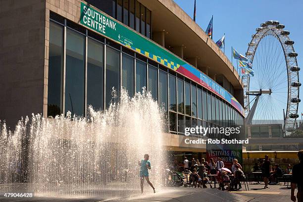 People cool off in a fountain outside the Southbank Centre on June 30, 2015 in London, England. The UK is currently experiencing a heatwave, with...