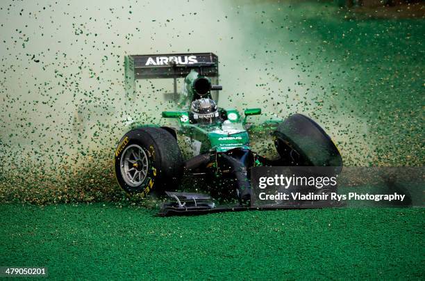 Kamui Kobayashi of Japan and Caterham gets off the track after crashing into Felipe Massa of Brazil and Williams during the Australian Formula One...