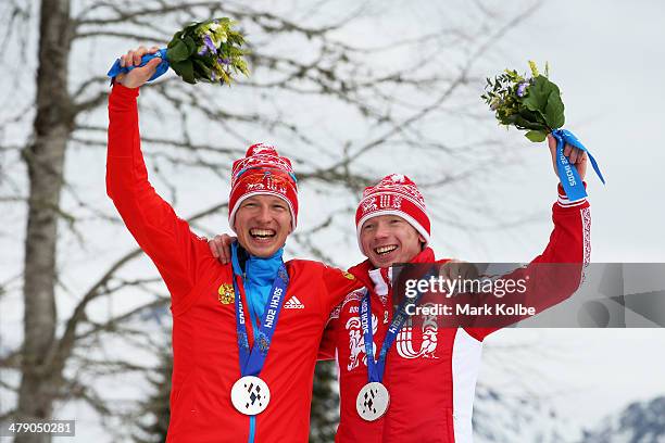 Silver medalist of Russia and guide Maksim Pirogov pose during the medal ceremony for the Mens Cross Country 10km Free  Visually Impaired on day...